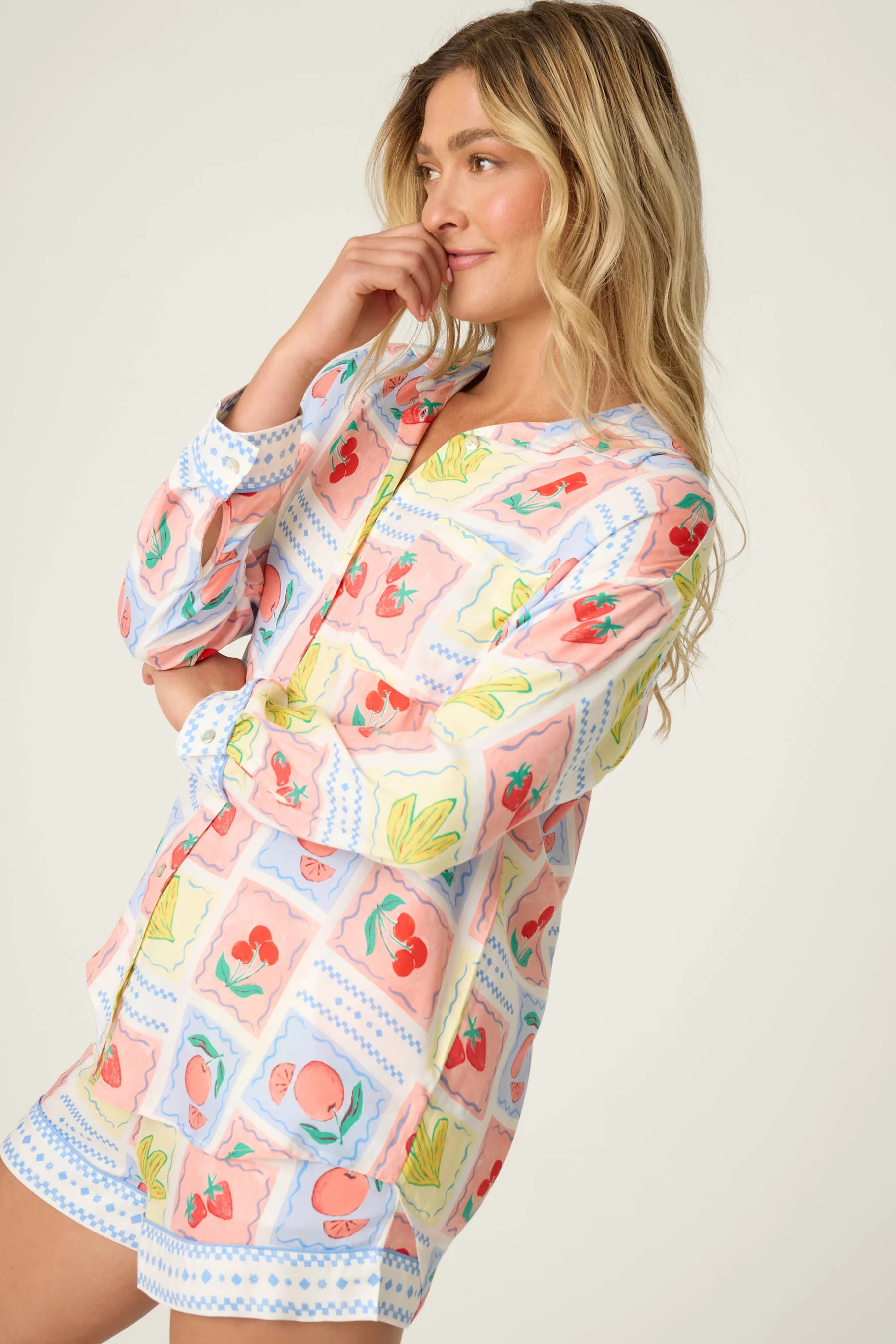Frutta Fresca Summer Harvest Button Up Top & Short Set PJ Salvage modeled by a woman in a colorful fruit print.