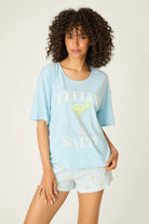 Playful Prints Feeling Salty Graphic Tee by PJ Salvage worn by a model with curly hair, showcasing a fun margarita design.