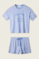PJ SALVAGE Graphic Print Softee Tee & Short Lounge Set in "Nap Time is my Happy Hour" graphic tee shirt in light blue. Product lay flat on a light background shot