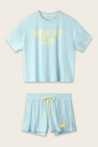 PJ SALVAGE Graphic Print Softee Tee & Short Lounge Set in "Breakfast Club" graphic tee shirt in light blue. Flat lay of product against a light background 