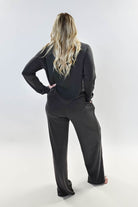Model wearing Long Sleeve Raw Edge Straight Pant Lounge Set from the back, showcasing its relaxed fit and stylish design.