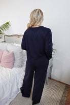 Back view of model wearing Long Sleeve Raw Edge Straight Pant Lounge Set in navy blue.