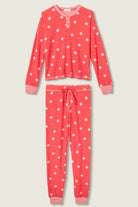  Woman wearing Ski Jammie Classics Brushed Thermal PJ Set, featuring playful winter prints in red and pink snowflake wishes.