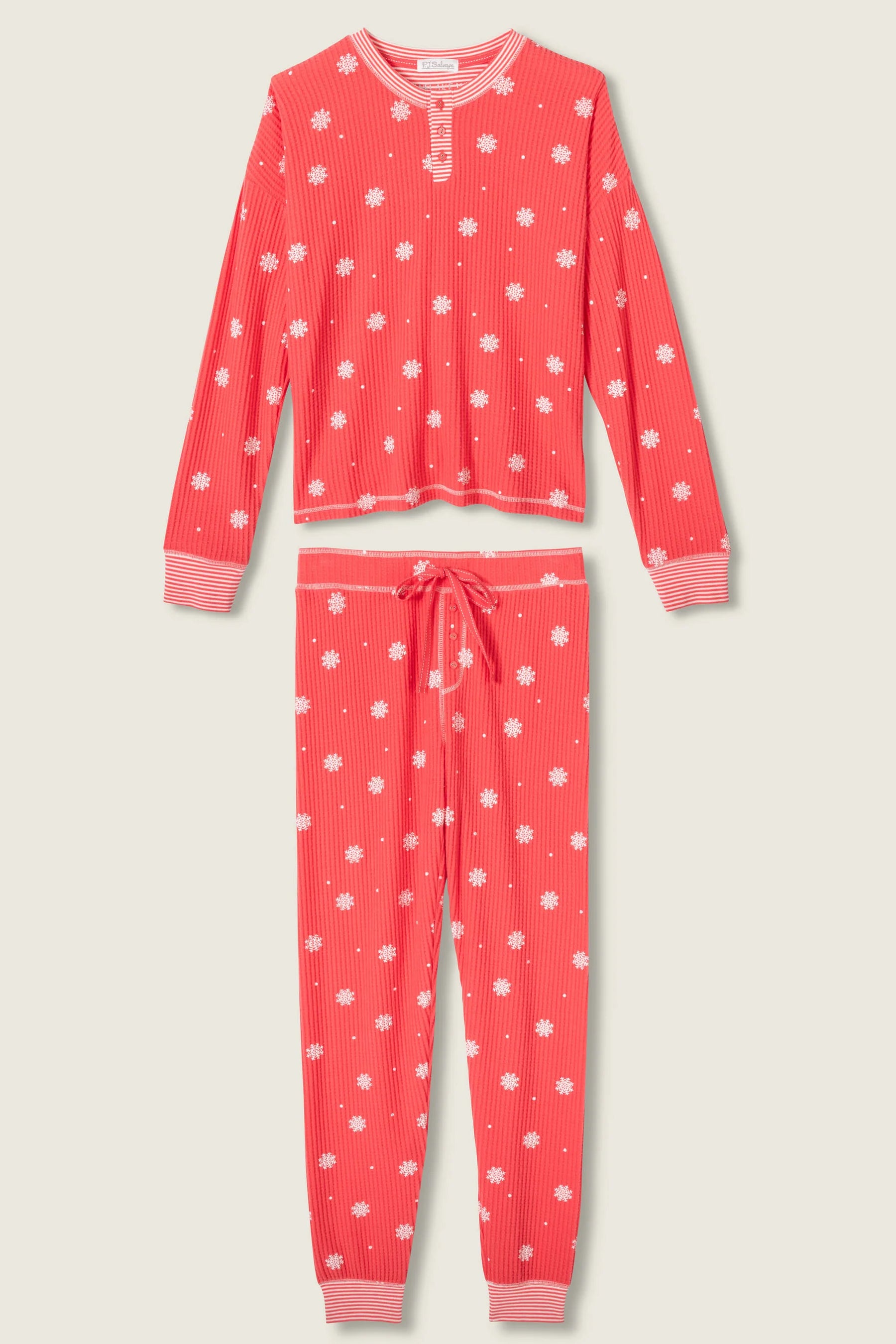  Woman wearing Ski Jammie Classics Brushed Thermal PJ Set, featuring playful winter prints in red and pink snowflake wishes.