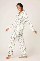 Model wearing the Sleigh All Day Flannel 3-Piece PJ Set featuring a playful dog print against a winter-white backdrop.