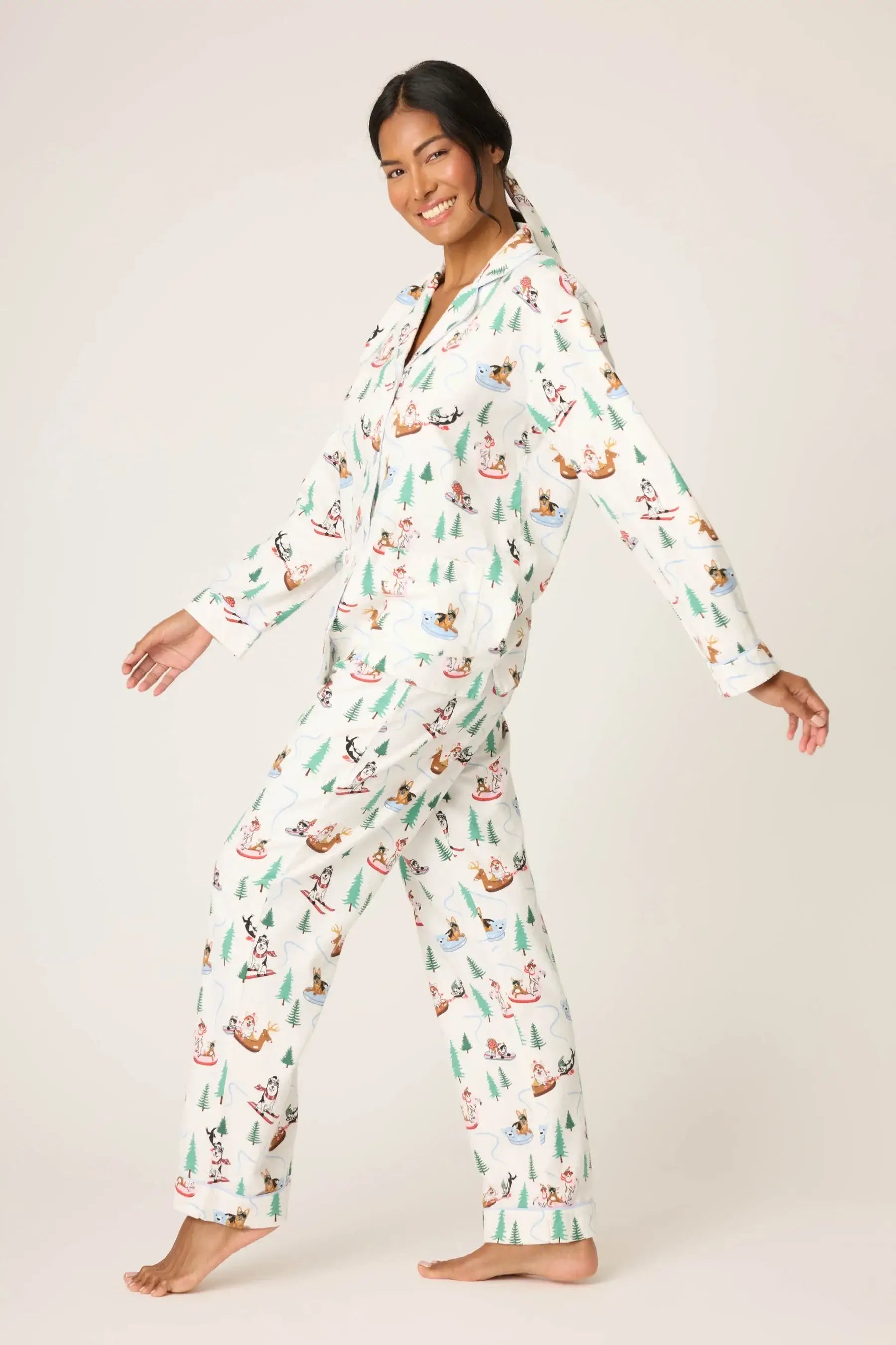 Model wearing the Sleigh All Day Flannel 3-Piece PJ Set featuring a playful dog print against a winter-white backdrop.