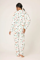 Woman wearing the Sleigh All Day Flannel 3-Piece PJ Set featuring fun dog prints and a winter-white backdrop.