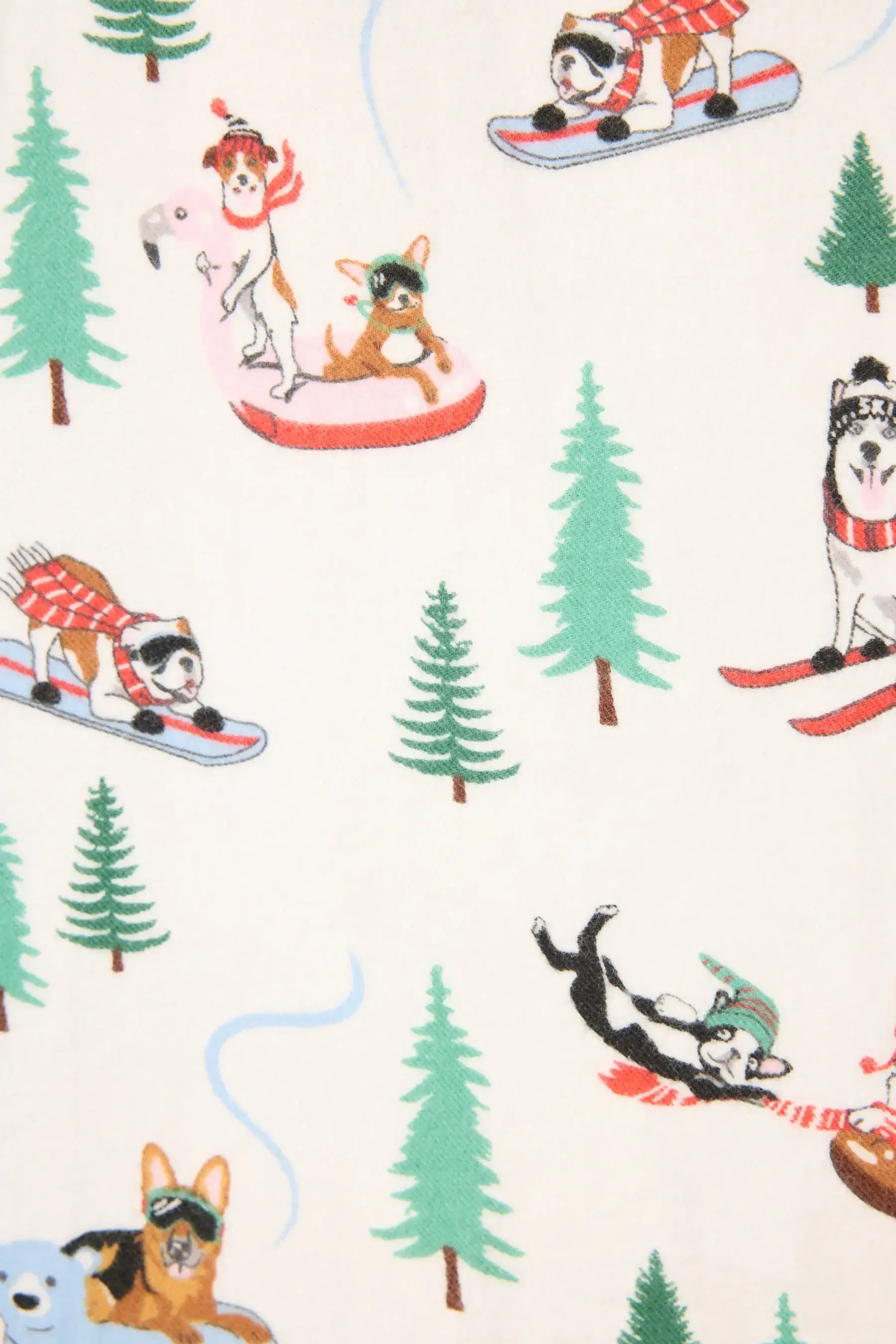 Sleigh All Day flannel PJ set featuring playful dog print skiing, sledding, and tubing on a winter-white backdrop.