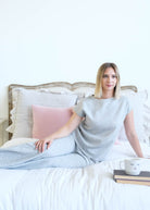 Miranda Nic The Robyn Lounge Set Heather Grey model lifestyle on bed with books and mug— Cloud Nine Pajamas Edmonton