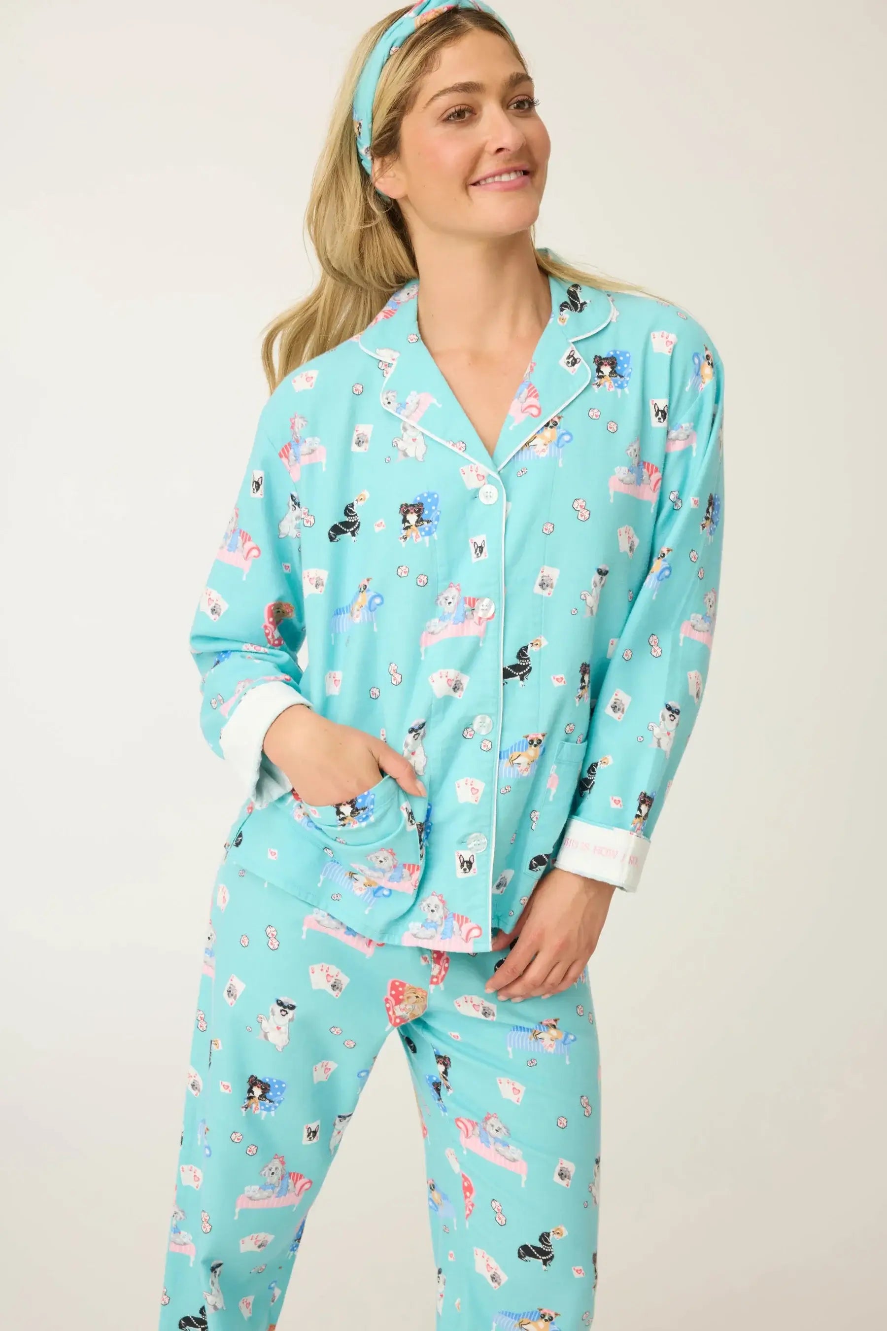 Woman wearing the This Is How I Roll Dog Print Flannel PJ Set by PJ Salvage, featuring playful dog designs and soft flannel material.