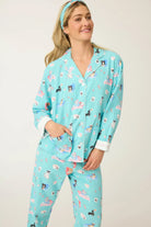 Woman wearing the This Is How I Roll Dog Print Flannel PJ Set by PJ Salvage, featuring playful dog designs and soft flannel material.