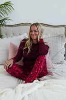 Vino Dreams PJ Long Sleeve Jogger Bamboo Set | GEORGIA RYLAN - model sits on bed wearing the set