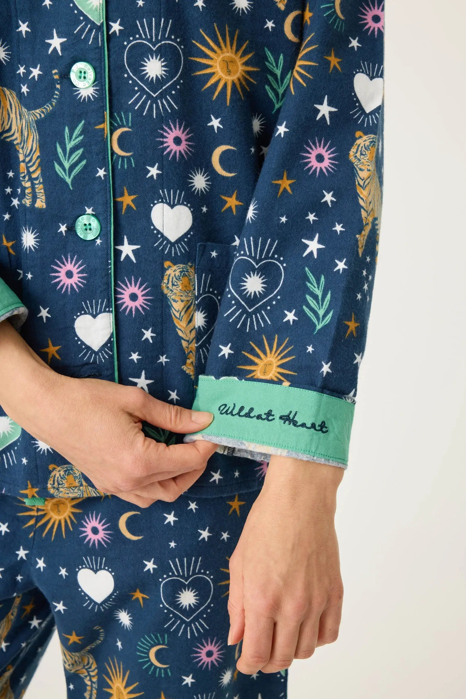 Close-up of Wild At Heart 3-Piece Flannel PJ Set with colorful patterns and embroidered cuff detail.