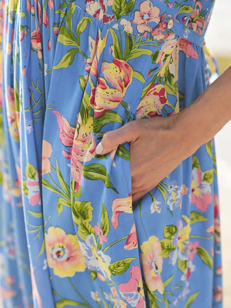 Close-up of April Cornell Lillian Rayon Dress showcasing its blue floral pattern and pockets.