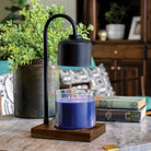 Candle Warmers Etc. Arched Lamp Black and Wood styled in living room with blue candle — Cloud Nine Pajamas
