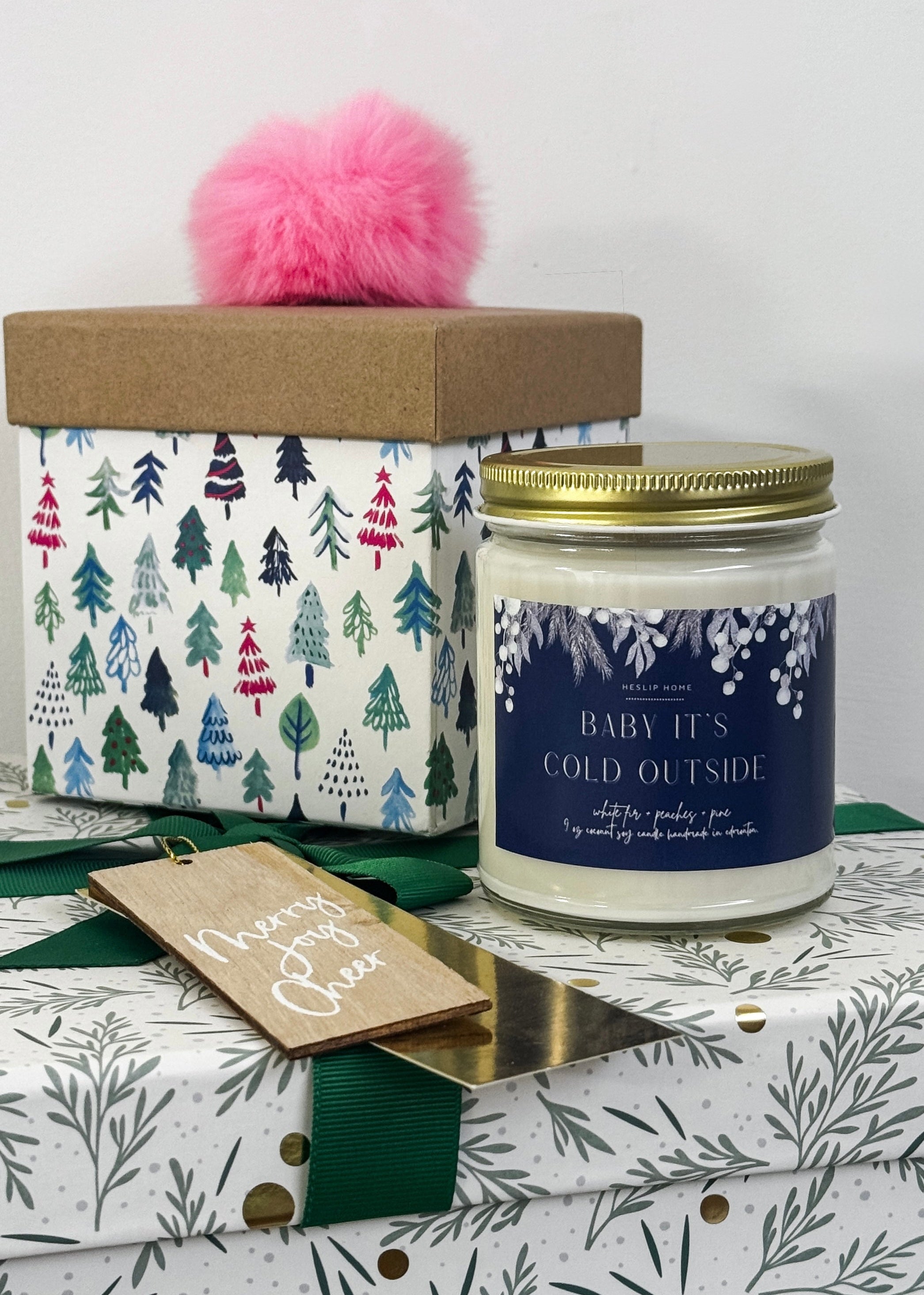 baby its cold outside candle with notes of the woods - fir and pine - plus sweet peaches