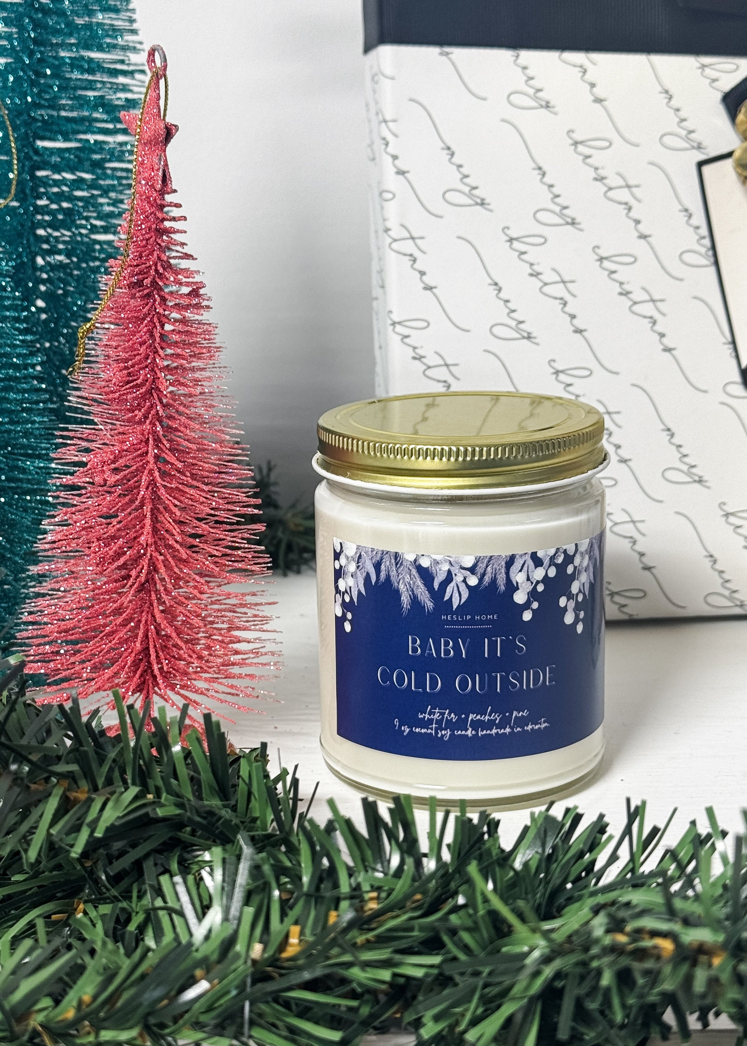 baby its cold outside candle with notes of the woods - fir and pine - plus sweet peaches