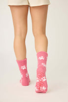Pair of PJ Salvage Pink Fuzzy Cozy Socks with the adorable all-over paw print design. Showing the plush texture and mid-height crew cut.