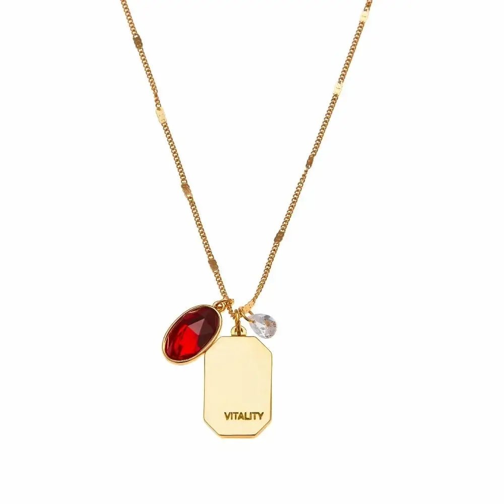 Birthstone Charm Necklace in 14k Plated Gold featuring a ruby stone, labeled 'Vitality', by Foxy Originals. Birthstone Charm Necklace in 14k Plated Gold for JUNE featuring a ruby stone, labeled 'Vitality', by Foxy Originals.