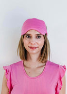 Bubblegum Pink Bamboo Sleep Eye Mask worn by a woman in pink top for comfortable sleep.