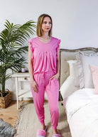 Bubblegum Pink Flutter Top and Jogger Bamboo PJ Lounge Set worn by a model in a cozy bedroom setting.