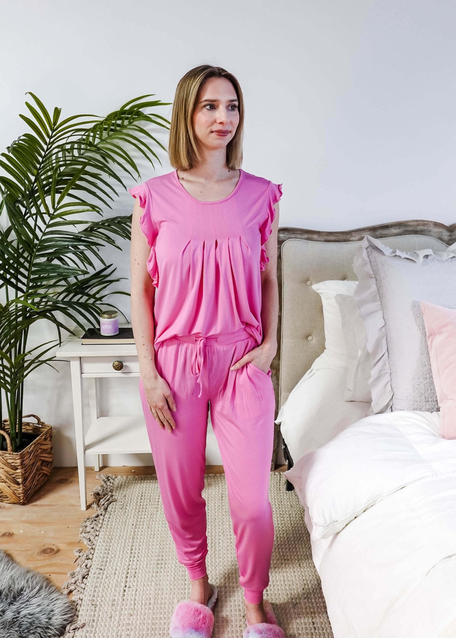 Bubblegum Pink Flutter Top and Jogger Bamboo PJ Lounge Set worn by a model in a cozy bedroom setting.