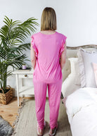 Bubblegum Pink Flutter Top and Jogger Bamboo PJ Lounge Set worn by a woman from behind, showcasing its flowy design.