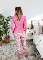 Woman wearing the Dream In Blooms Long Sleeve Top & Jogger Bamboo Lounge Set, seen from behind in a cozy bedroom.