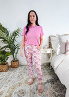 Model wearing Dream In Blooms Tee & Jogger Bamboo Lounge Set, featuring bubblegum pink tee and floral joggers.