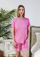 Model wearing a Bubblegum Pink Tee Short Bamboo Pajama Set, featuring a stylish pocket and comfortable fit.