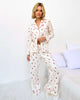 Model wearing the Flora Pillowsoft Sleep Set Splendid, featuring silky soft button-down pajamas with a cherry design.