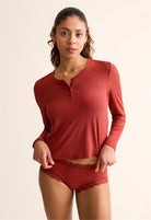 Close-up of the functional Henley buttons and the luxurious, soft texture of the TENCEL™ Modal fabric.