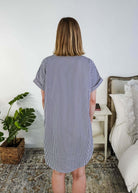 Person wearing a blue and white striped dress in a bedroom setting, Scarlett Ellie Collared Button-Up Short Sleeve Dress | Cloud Nine Pajamas