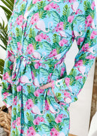 Cooling Bamboo Short Robe with Pockets  Tropic Like It's Hot Bamboo Short Robe | Georgia Rylanclose up of print of pink flamingos and orchids on a sky blue background and green tropical leaves
