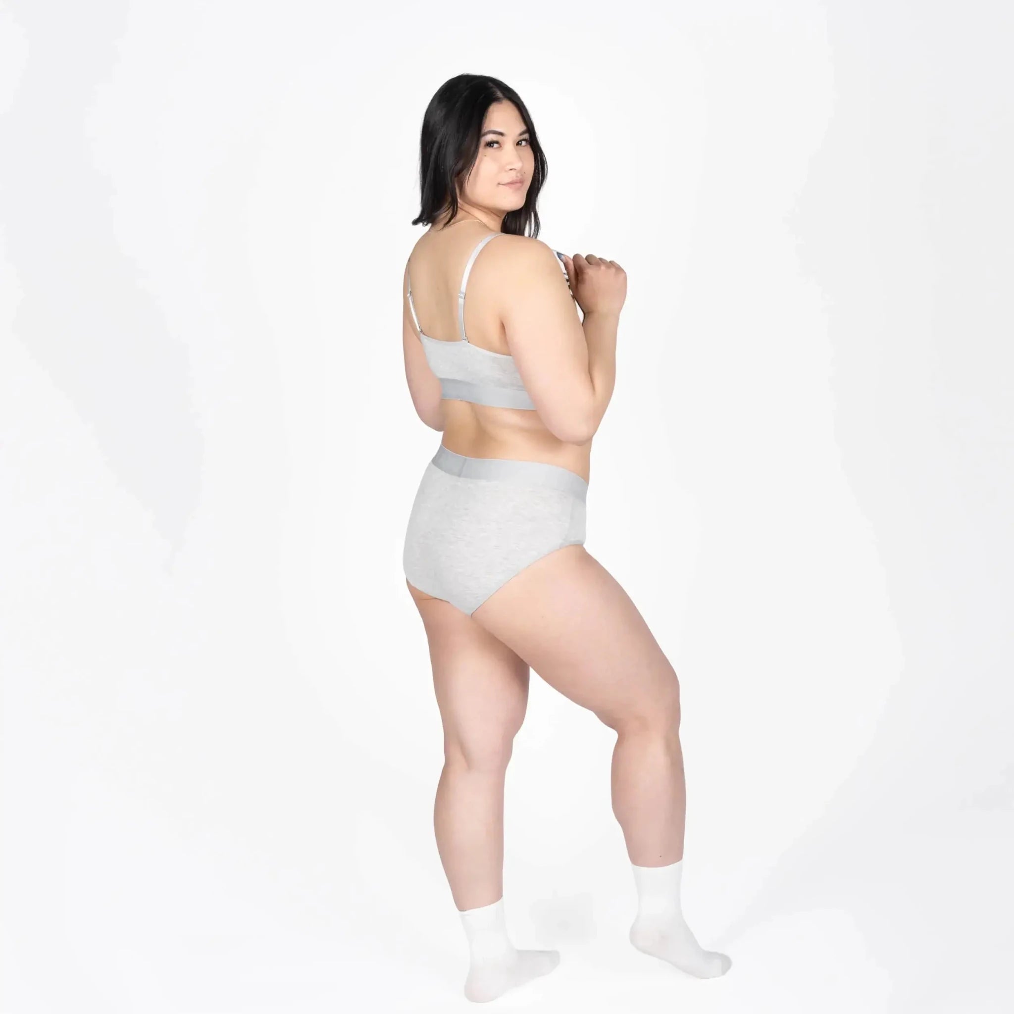 Model wearing Devon + Lang Bria Full Coverage Bikini Brief and matching bralette in gray.