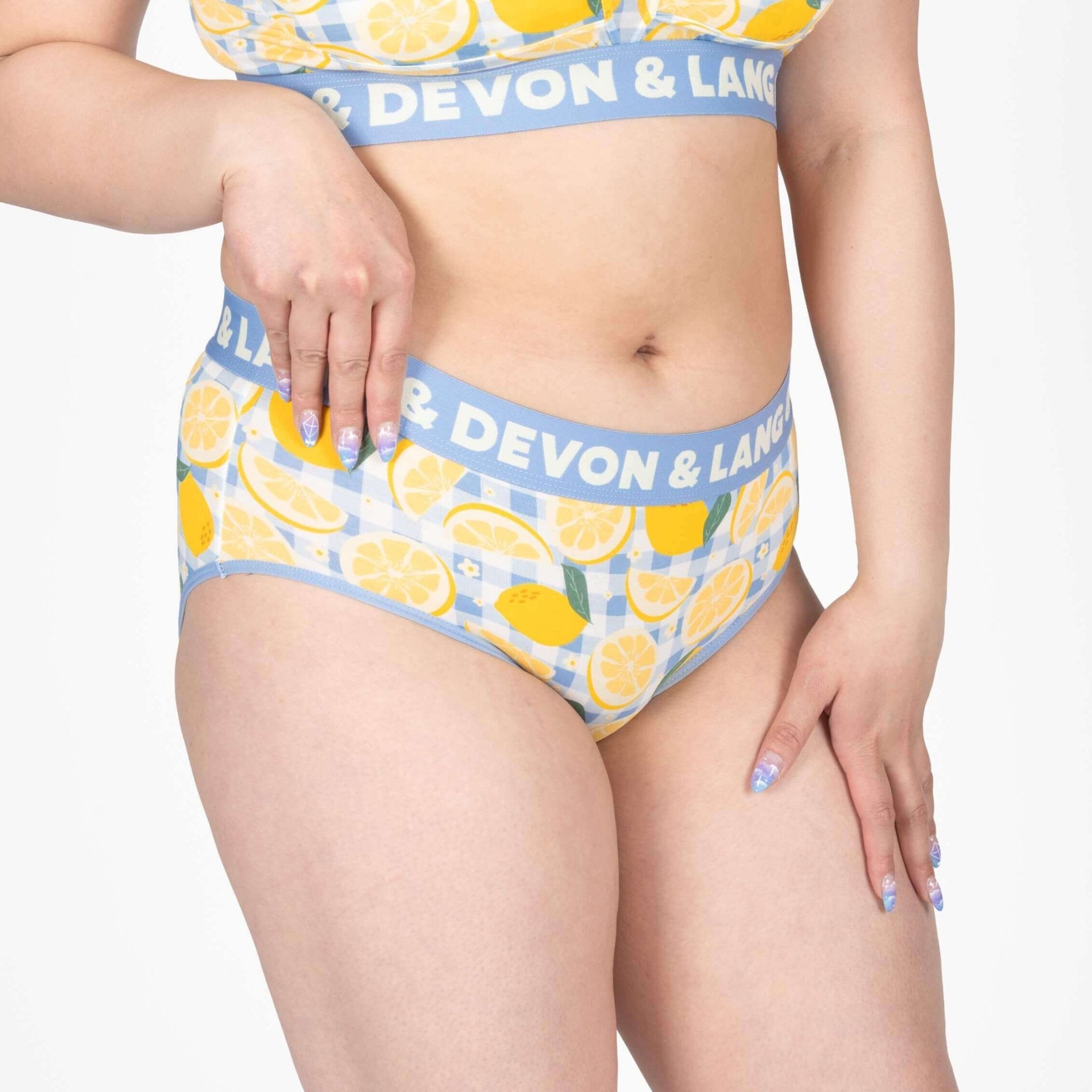 Model wearing Devon + Lang Bria Full Coverage Bikini Brief with lemon print, showcasing comfort and style.