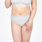Model wearing Devon + Lang Bria Full Coverage Bikini Brief in light gray.