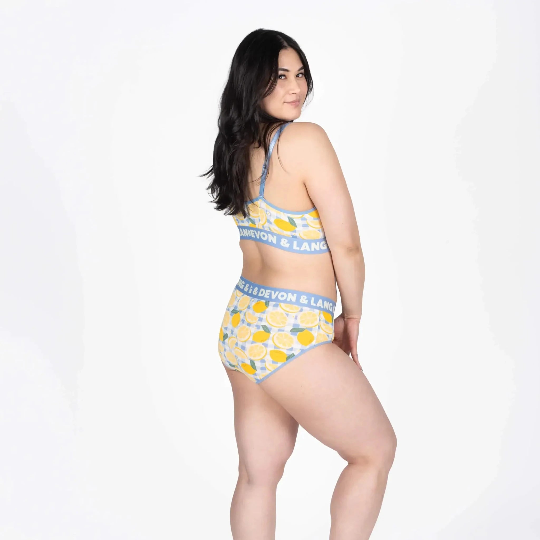 Devon + Lang Bria Full Coverage Bikini Brief in a vibrant lemon pattern, showcased on a model from the side.