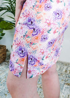 Dream in Blooms V Neck Nightshirt With Pockets featuring a vibrant floral design and side slits for added comfort.