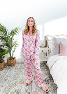 Dream in Blooms Long Sleeve Button Up & Pant Bamboo Lounge Set worn by a model in a cozy bedroom setting.