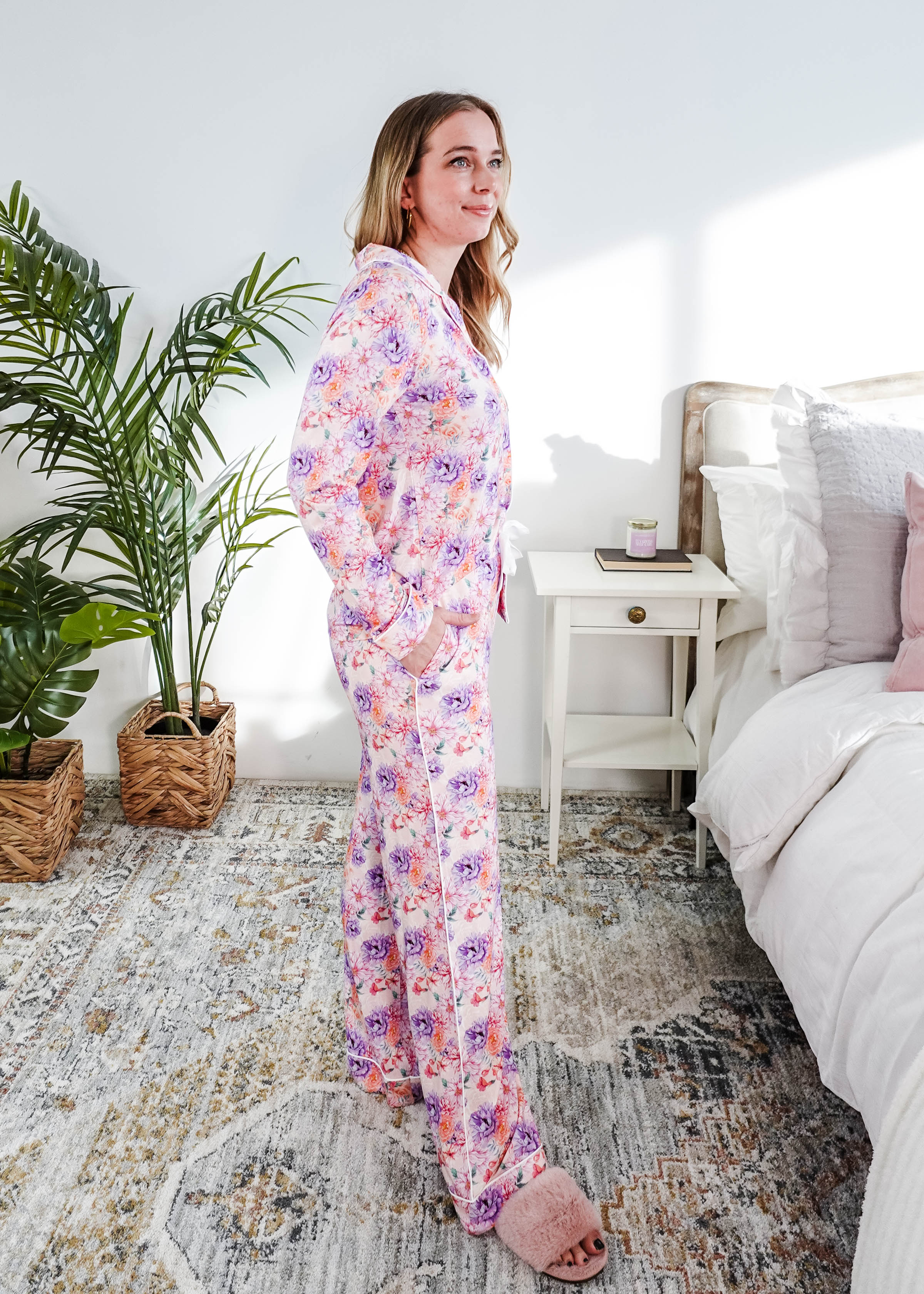 Model wearing Dream in Blooms Long Sleeve Button Up & Pant Bamboo Lounge Set in a bright bedroom setting.