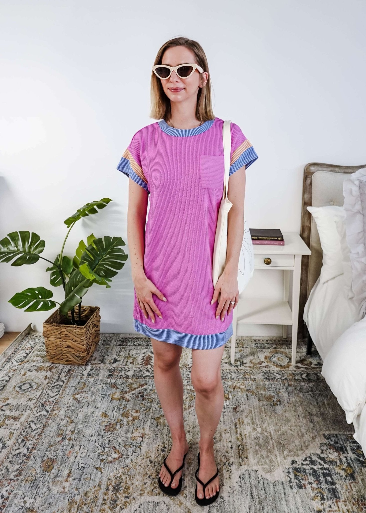 Woman wearing a pink  dress with purple and peach sleeve dress in a bedroom setting, Scarlett Ellie Everyday Relaxed T-Shirt Dress | Cloud Nine Pajamas