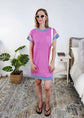 Woman wearing a pink  dress with purple and peach sleeve dress in a bedroom setting, Scarlett Ellie Everyday Relaxed T-Shirt Dress | Cloud Nine Pajamas