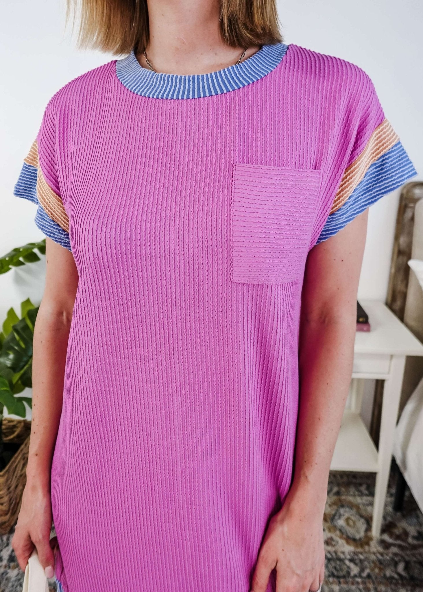 Woman wearing a pink  dress with purple and peach sleeve dress in a bedroom setting, Scarlett Ellie Everyday Relaxed T-Shirt Dress | Cloud Nine Pajamas