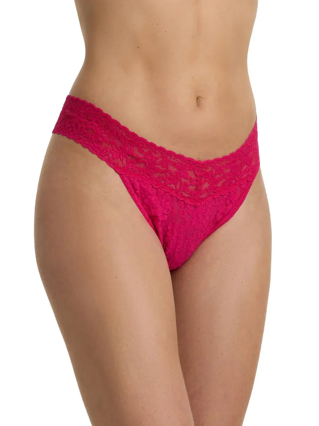 Hanky Panky Original Rise Thong in bright pink lace on a model's waist, showcasing signature lace design.