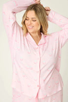 Happy Hour Wine Glass Print 3-Piece PJ Set Plus Size Inclusive model wearing playful pink pajama set with wine glass pattern, smiling.