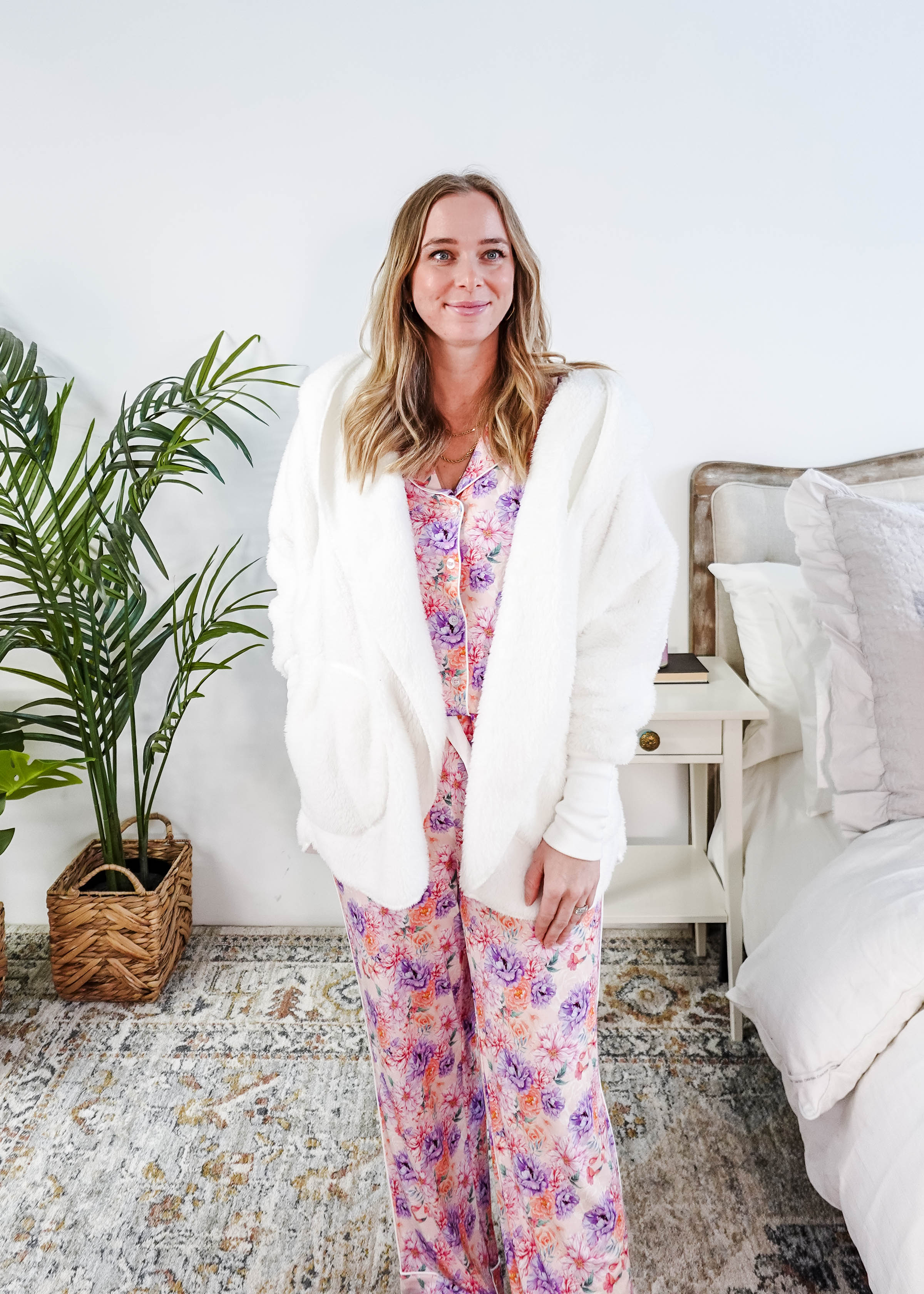 Essential Hooded Fluffy Cozy Cardigan with Pockets worn by a woman with floral pajamas in a cozy bedroom setting.