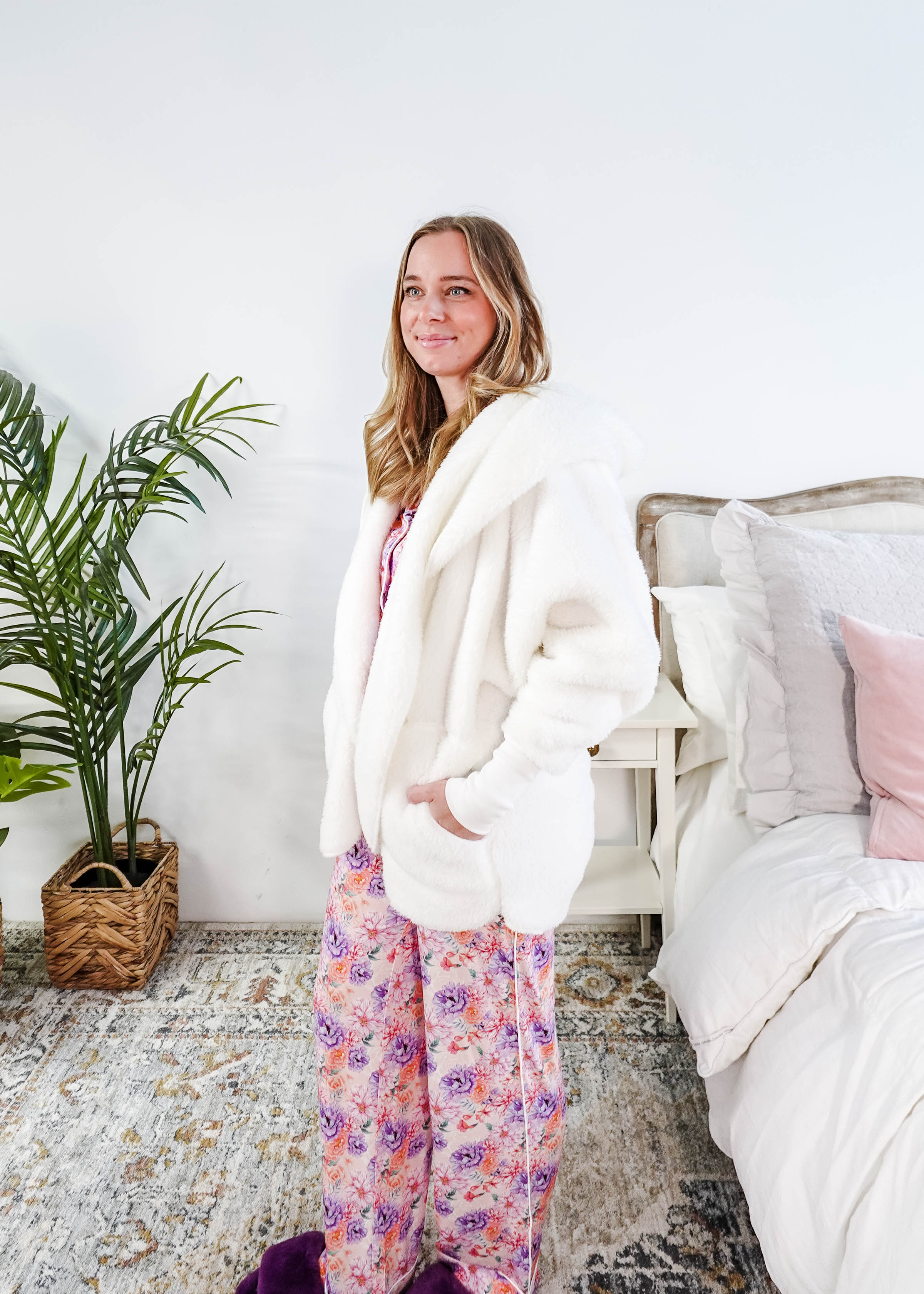 Essential Hooded Fluffy Cozy Cardigan with Pockets worn by a woman with floral pajamas in a cozy bedroom setting.