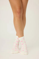 Pair of PJ Salvage "Love You A Latte" Fuzzy Crew Socks in ivory with an all-over pink heart print. Showing the mid-height crew cut and plush texture.
