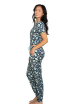 Latte Love Floral Print Cotton-Modal Relaxed Set Drop Shoulder Tee & Jogger Set modeled by a woman in profile.